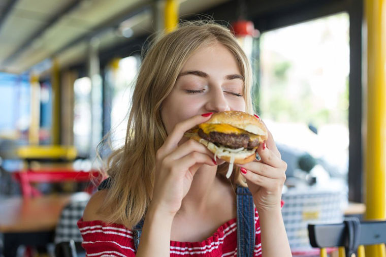 Woman eating a hamburger