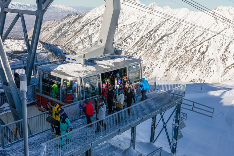 Skiers and snowboarders getting off Aerial Tram